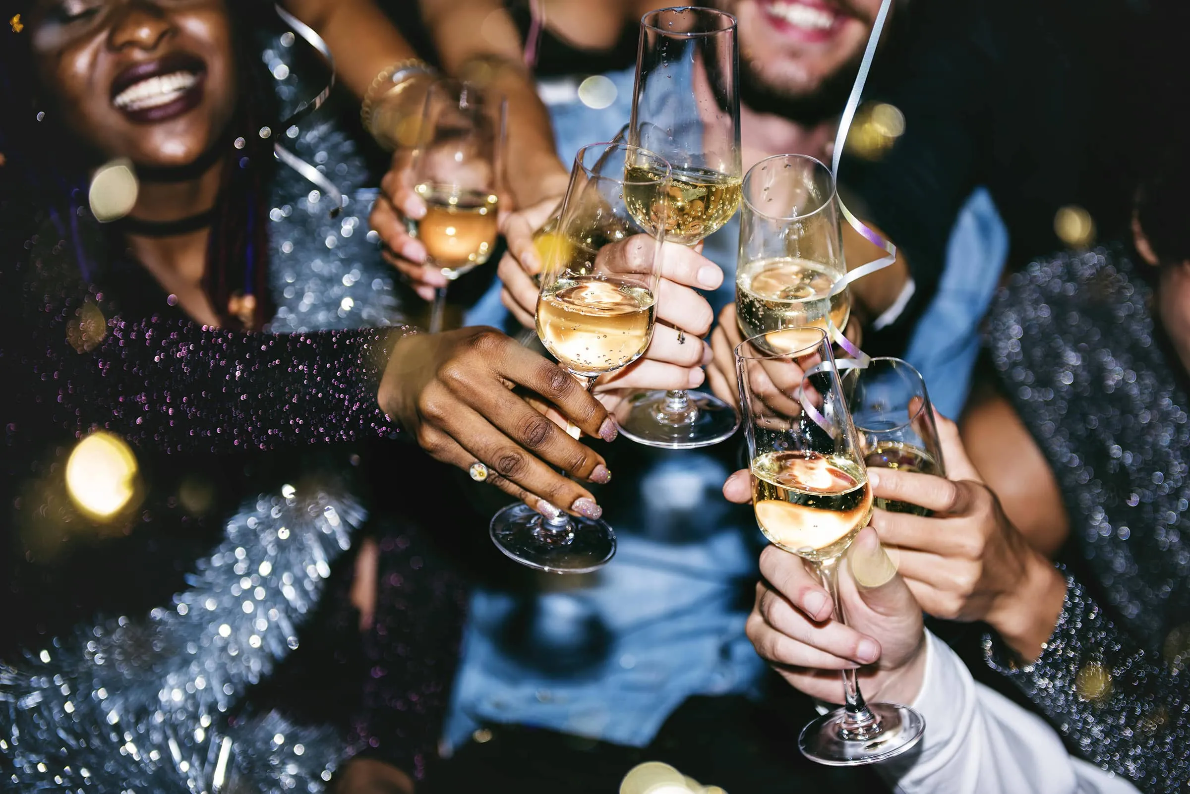 Friends raising glasses of fizz at a Christmas party